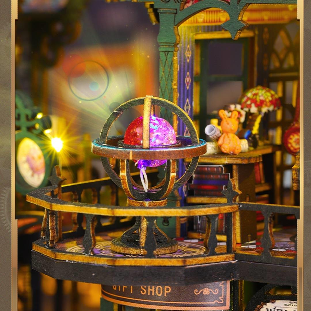 Decorative miniature model of a shop with a glowing orb inside