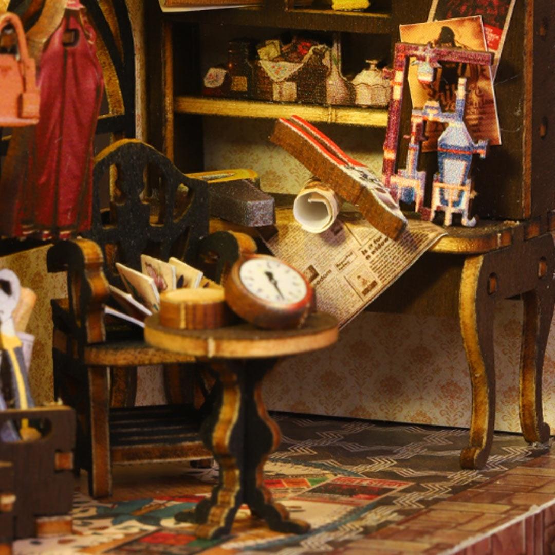 Miniature room setup with furniture and decorative items on a checkered floor.