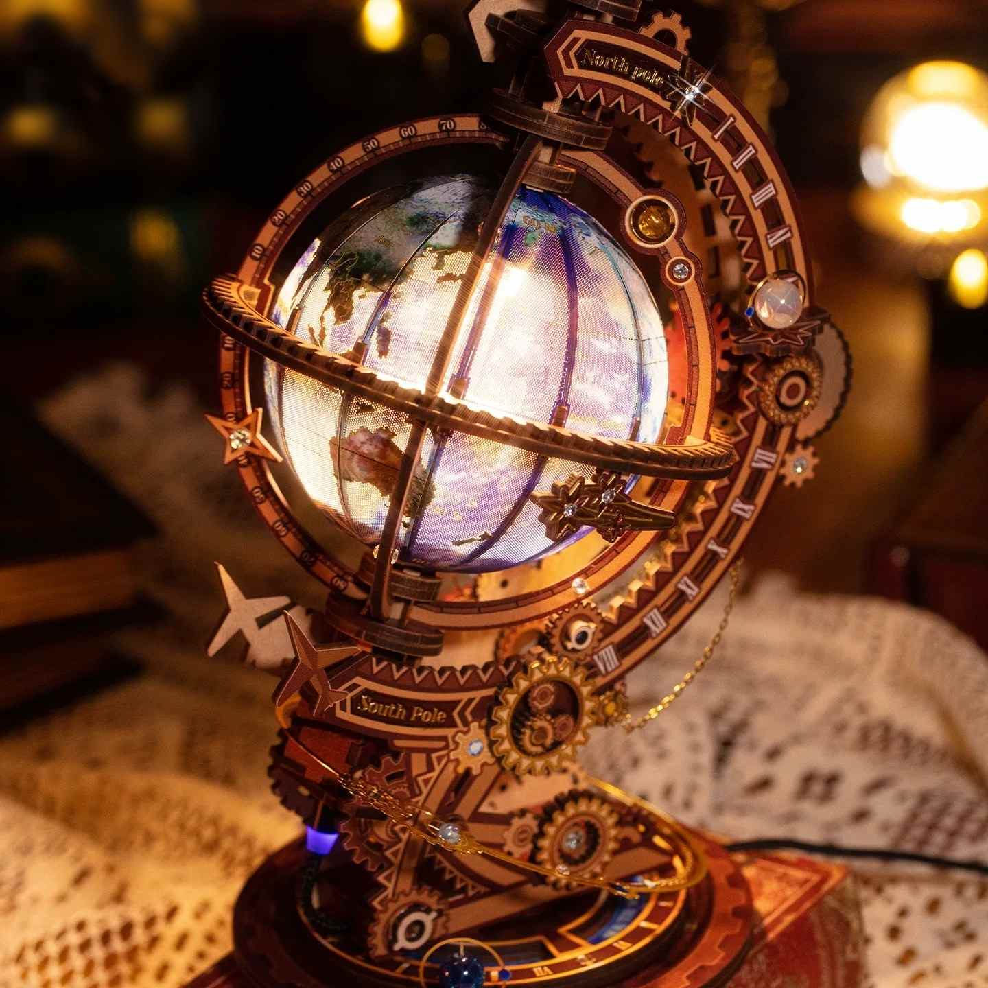 lit metal globe model with mechanical design on a table