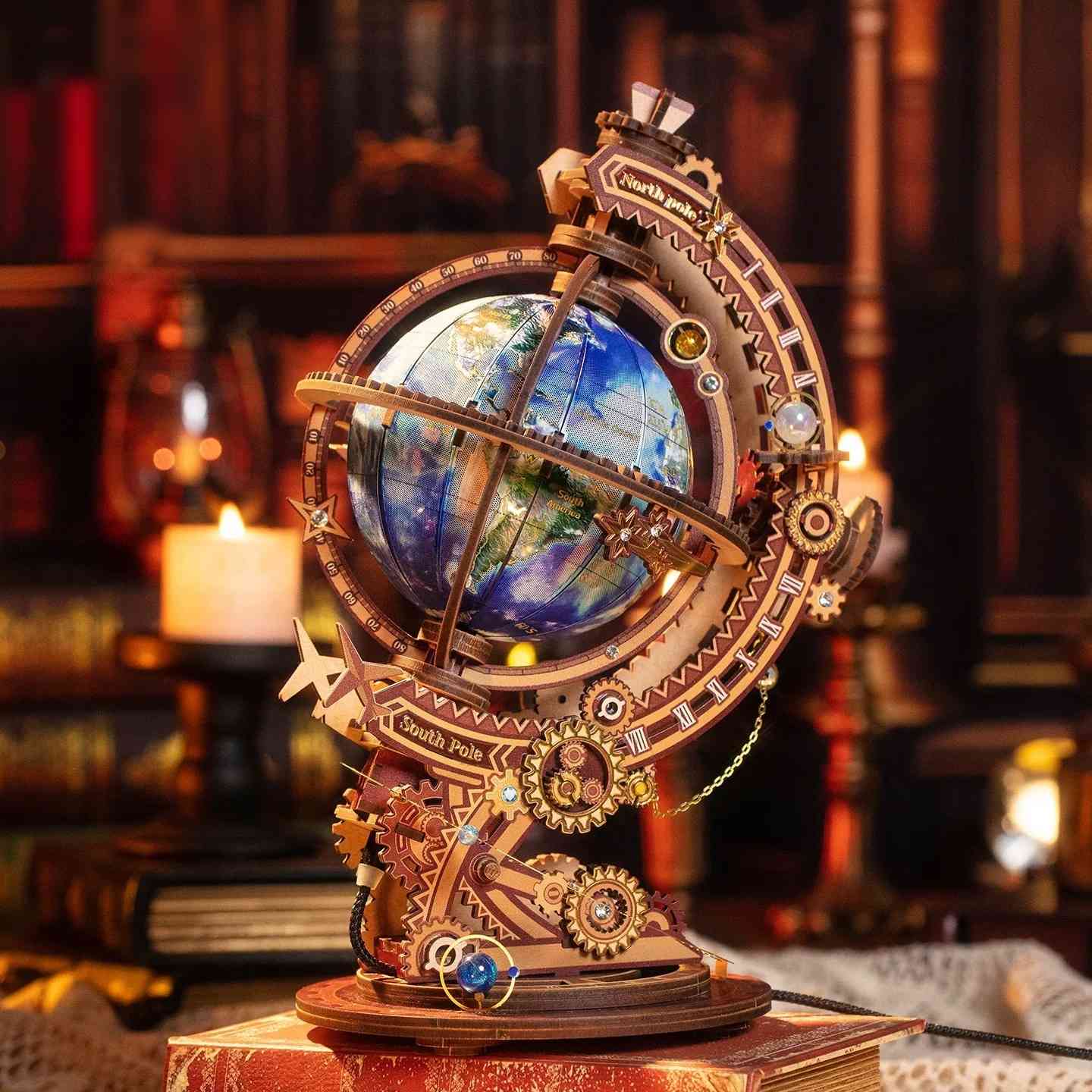 metal globe model kit with mechanical elements on a wooden base in a warm, candlelit room.