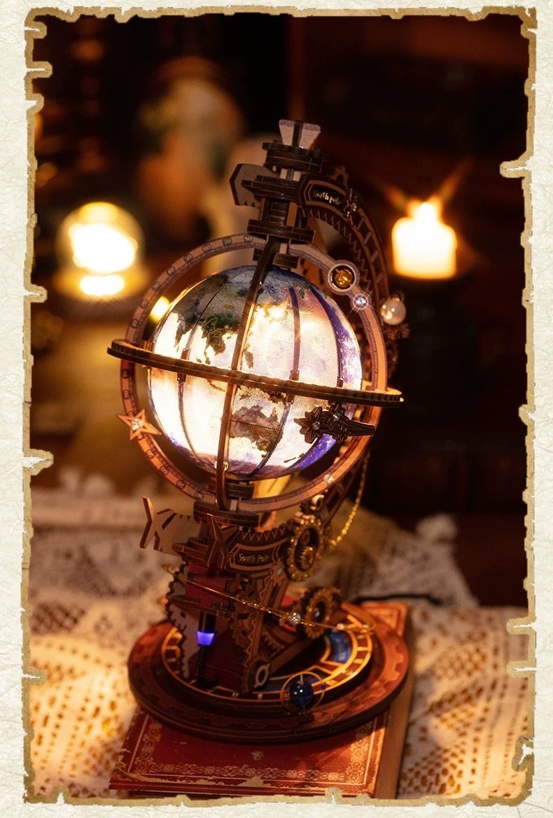 Decorative steampunk-style globe metal model with intricate details on a textured surface.