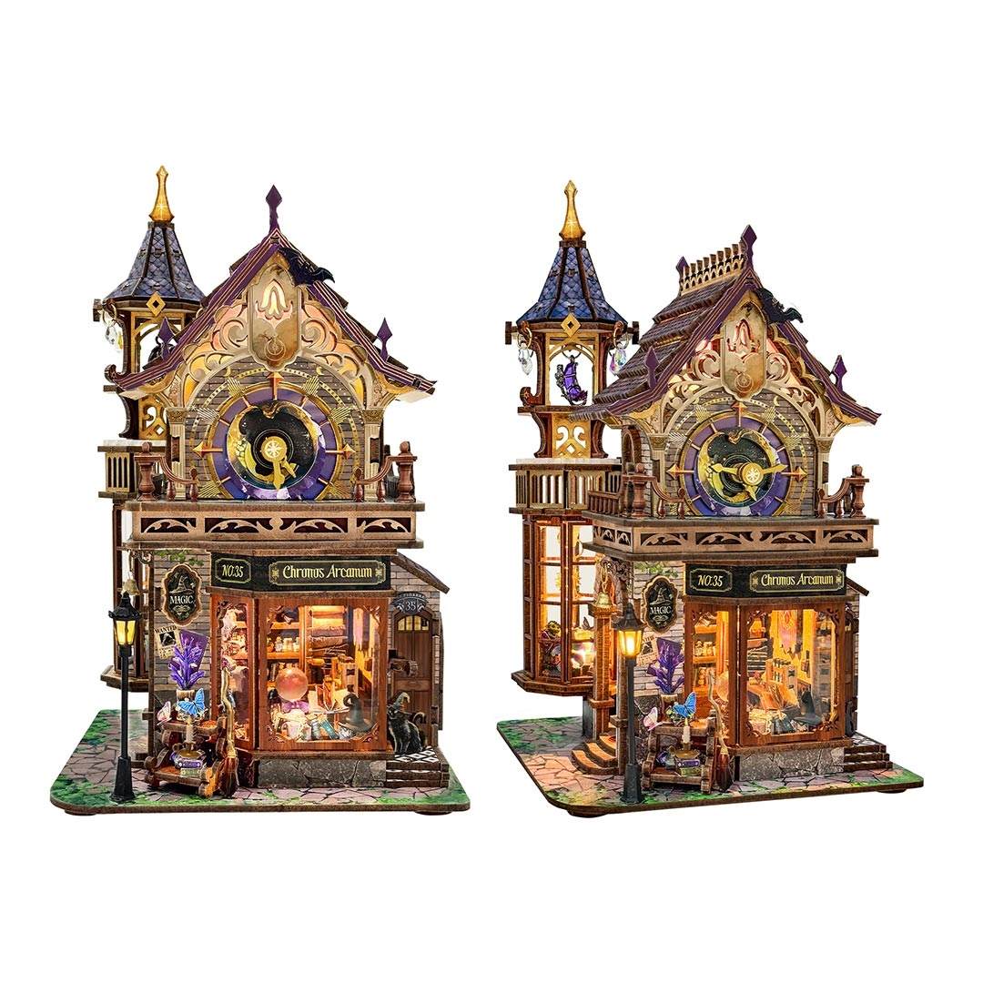Two intricately designed miniature house of magic shop themed with clock towers on a white background