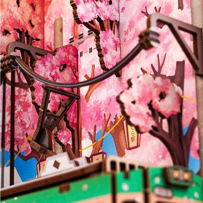 Japanese Sakura Densya DIY Book Nook Kit, A charming miniature 3d wooden puzzles the captures the essence of springtime in Japan, perfect for bookshelf decor or a delightful gift for Japanese culture lovers.