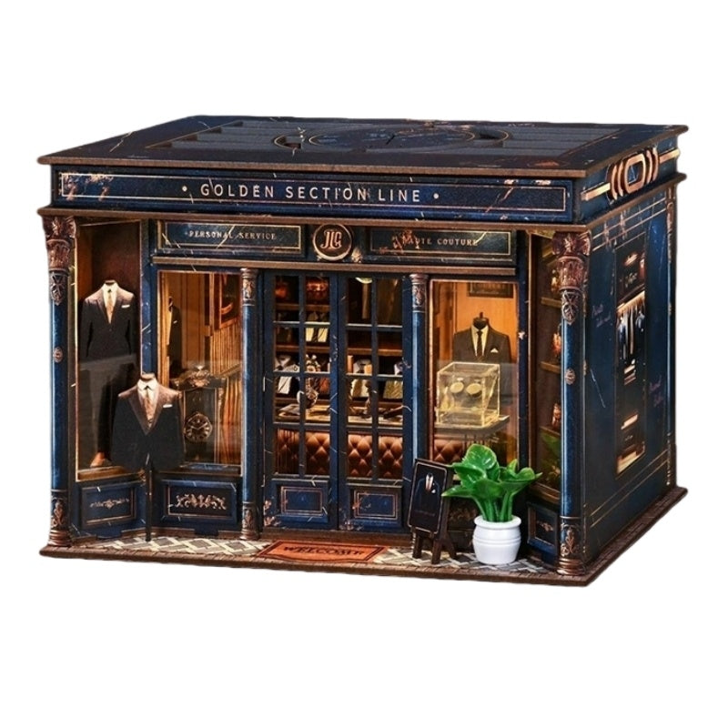 tailor shop themed miniature house with a miniature suit, plants, and books