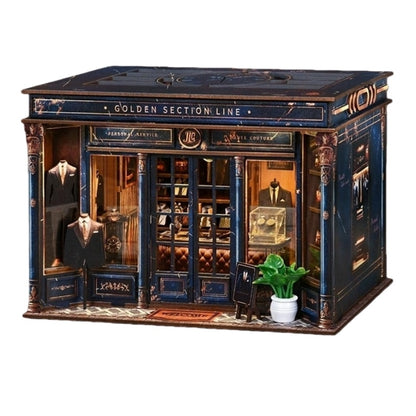 tailor shop themed miniature house with a miniature suit, plants, and books