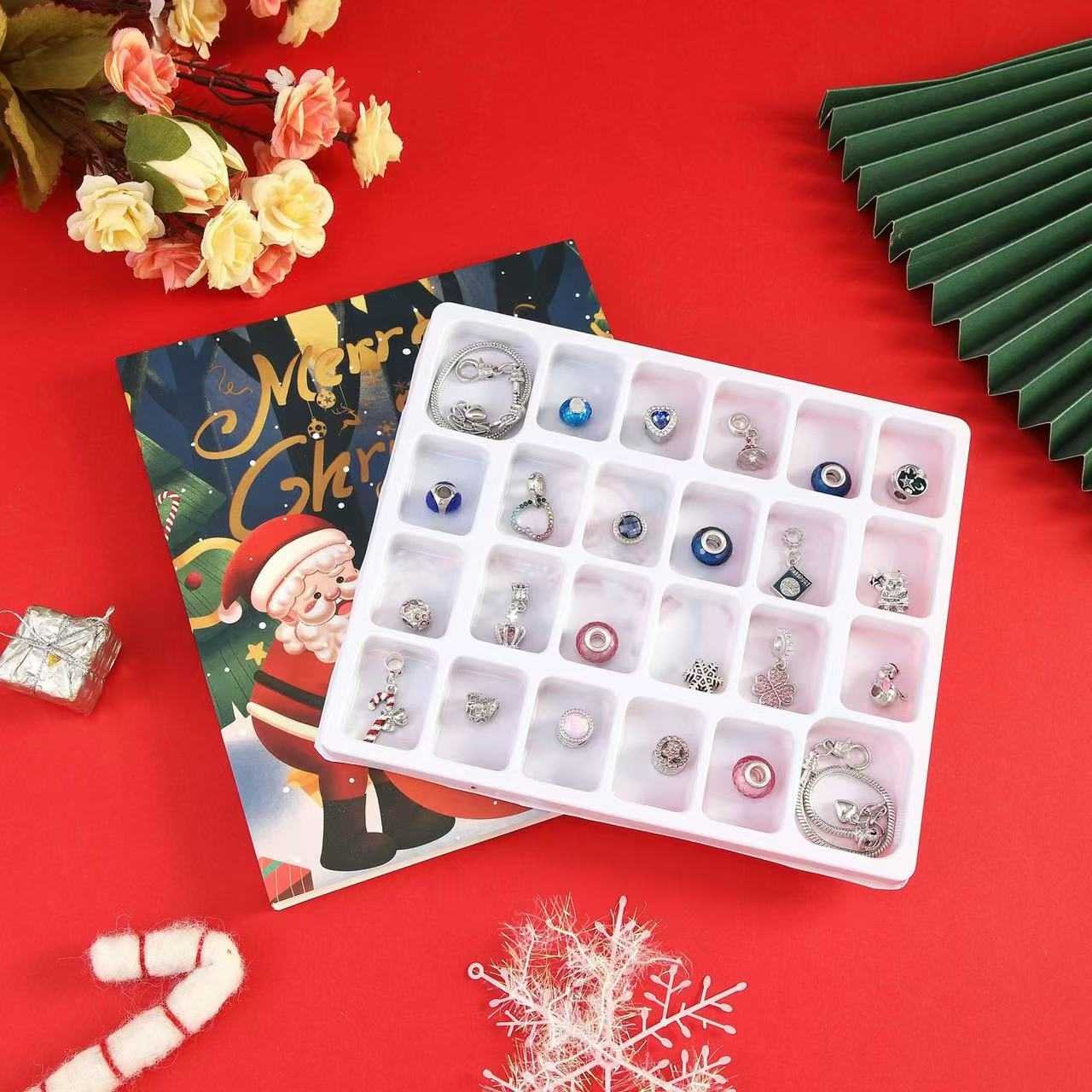 image displaying all the 22 charms and 2  bracelets of 24 Days Christmas Countdown Advent Calendar Bracelet Set in the box