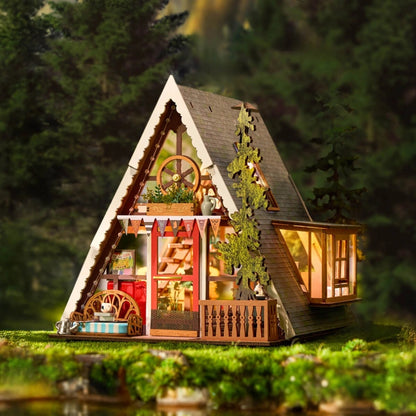 miniature Model of a cabin in the woods with glowing interior lights
