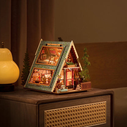 miniature Model of a cabin with interior lights on a wooden surface