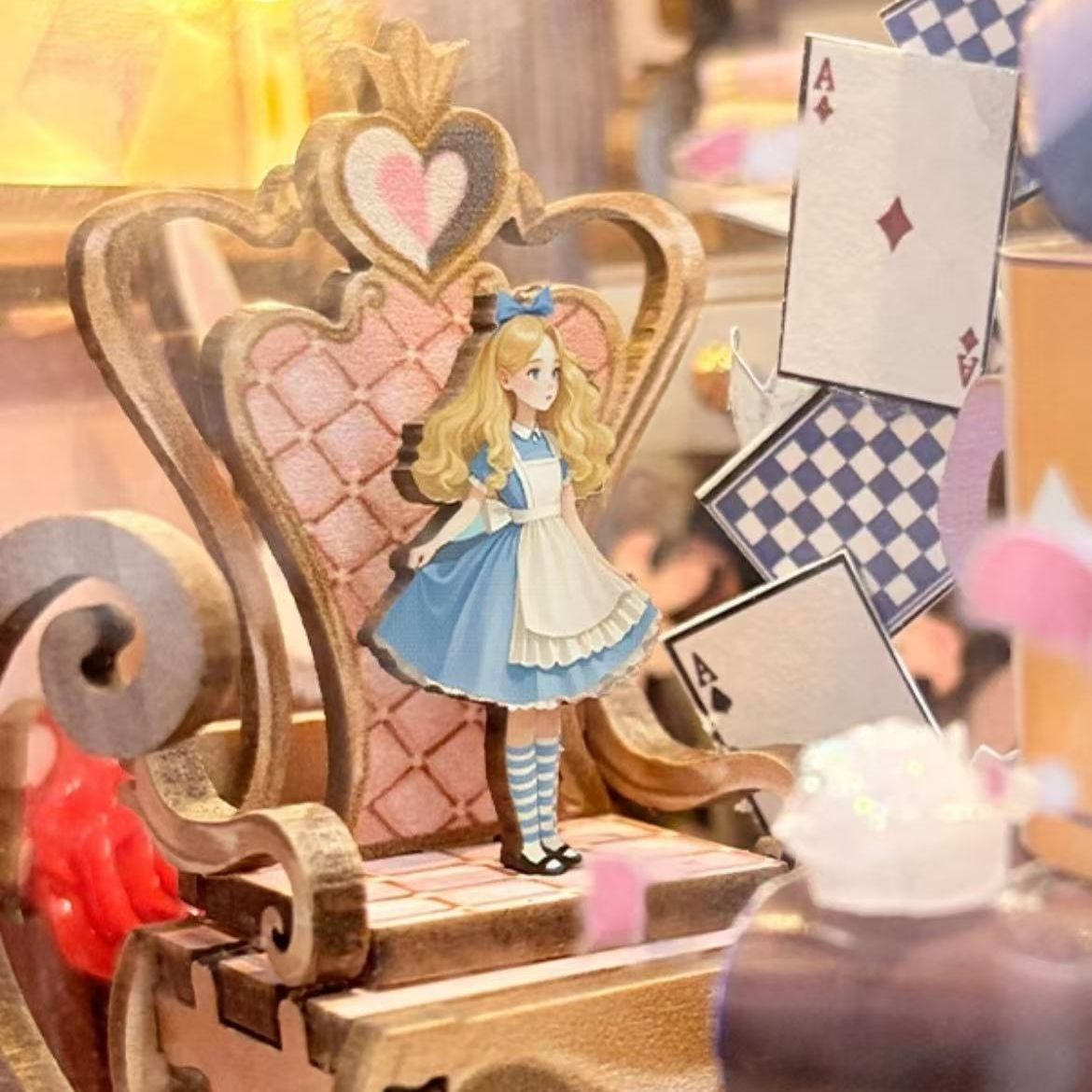 Alice in Wonderland-themed decorative set with a chair and playing card elements.