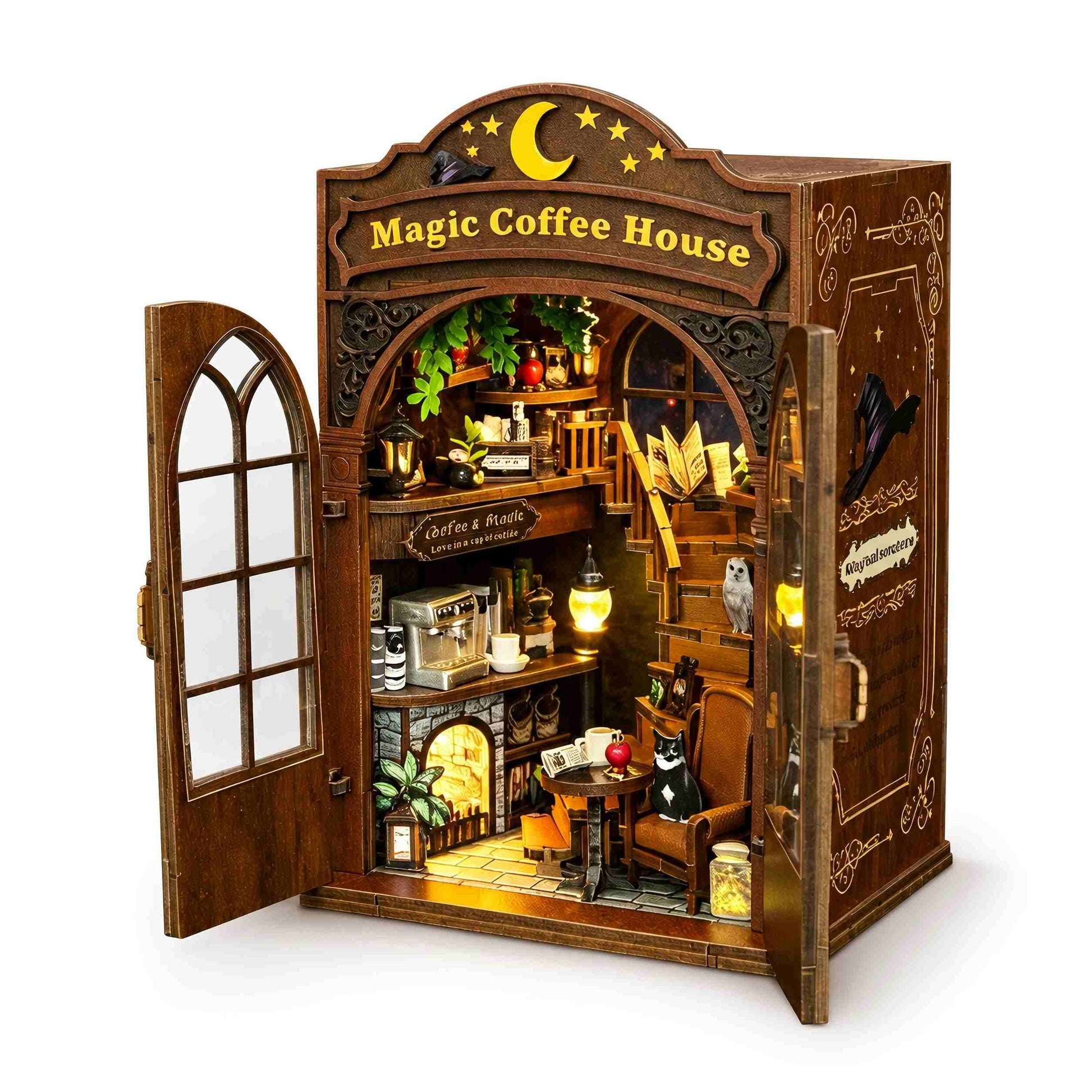 A miniature wooden diorama model of a cozy 'Magic Coffee House' with an open door, showcasing a detailed interior with a coffee bar, reading nook, and whimsical character figures, set against a plain white background.