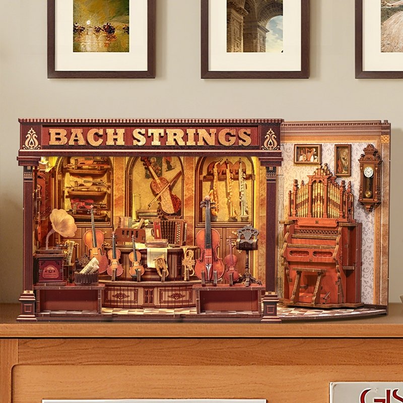 Wooden miniature house model of a music store named 'Bach Strings' with various musical instruments and door opened on a wooden shelf.
