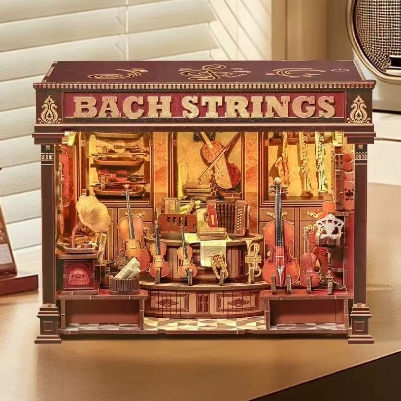 miniature house Model of a music store named 'Bach Strings' with various string instruments displayed inside, and warm light