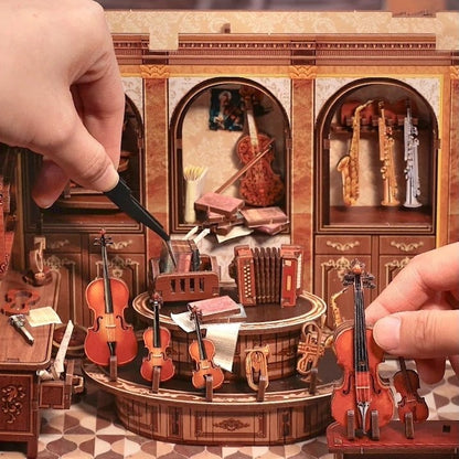 Detailed miniature orchestra model with a hand holding a violin