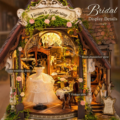 A highly detailed miniature display shop set under a sign reading 'Vivian's Tailoring' and 'Bridal Display Details,' featuring a lace wedding dress mannequin, warm chandelier glow, vintage table, floral decorations, and intricate carved woodwork.