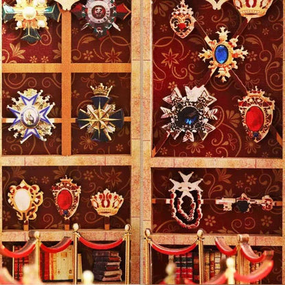 Decorative wall with ornate emblems and crowns in a museum-themed miniature house
