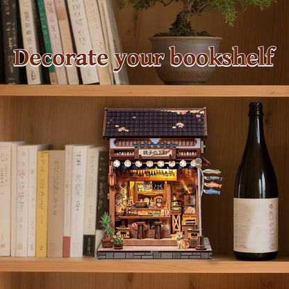 Miniature Book Nook of a Japanese Izakaya building on a bookshelf with books