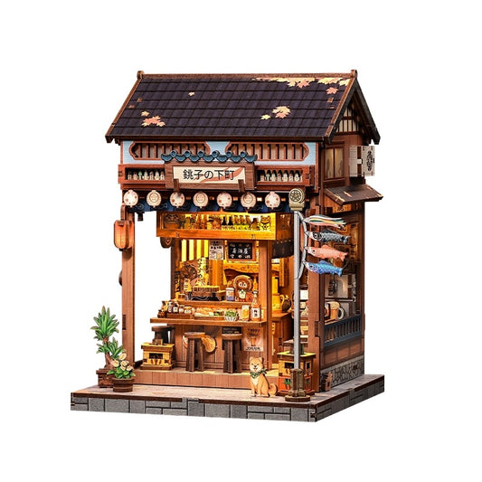 Miniature model of a traditional Japanese Izakaya building with various elements on a white background
