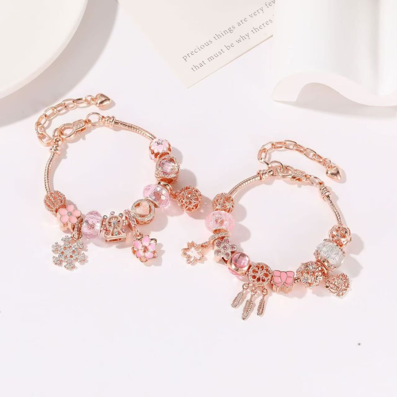 two assembled pink gold color DIY Christmas Advent Calendar Charm Bracelet Set on table