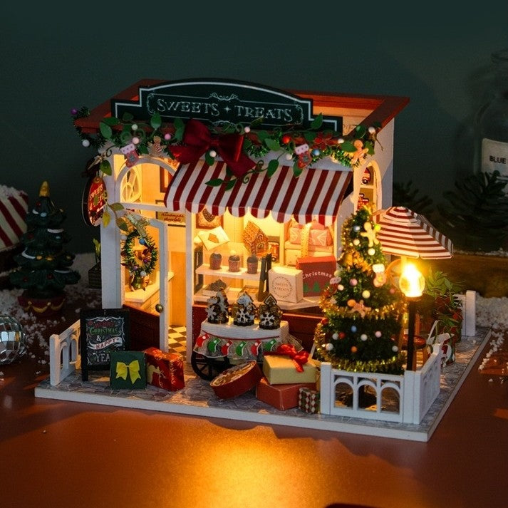 image showing a finished Christmas Dessert Shop DIY Miniature House Kit with warm LED light