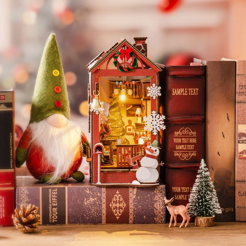 image displaying a finished Christmas House DIY Book Nook Kit in a Christmas-themed bookshelf setting