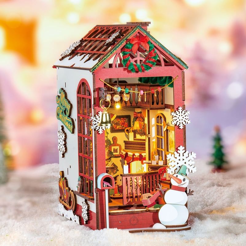 image displaying a finished Christmas House DIY Book Nook Kit in a Christmas-themed bookshelf setting