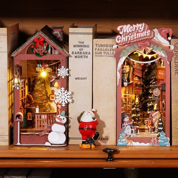 image displaying a finished Christmas Street DIY Book Nook Kit and Christmas House DIY Book Nook Kit in a bookshelf setting