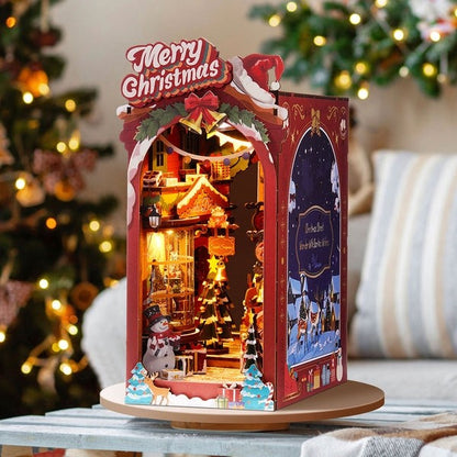 image displaying right side view of a finished Christmas Street DIY Book Nook Kit in a Christmas-themed table setting