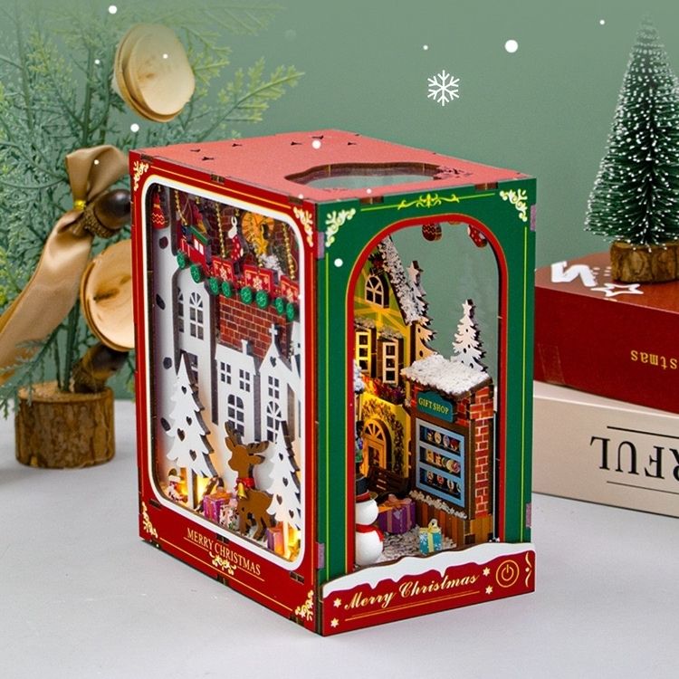 image displaying left side view of the assembled Christmas Winter DIY Book Nook kit in a Christmas-themed table setting