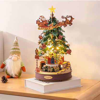 image displaying an assembled Christmas Melody Tree 3D Wooden Puzzle with light on in a table setting