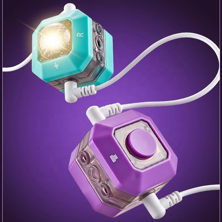 Two colorful electronic building blocks with lights and buttons on a purple background