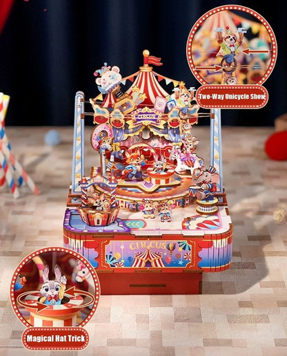 Colorful carnival-themed music box model set with various attractions on a wooden floor.