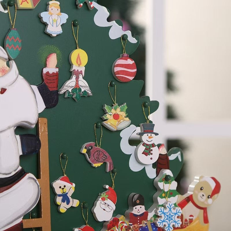 Christmas Countdown Wooden Advent Calendar featuring Santa climbing up a ladder alongside a decorated Christmas tree, 24 drawers on the base