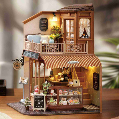Miniature model of a coffee shop with detailed interior and exterior elements, and warm Led lights on