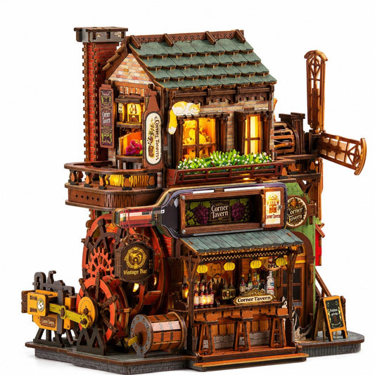 A highly detailed, multi-level wooden model of a Victorian-era mill and pub, featuring illuminated windows, gears, wheels, and a windmill, isolated on a white background.