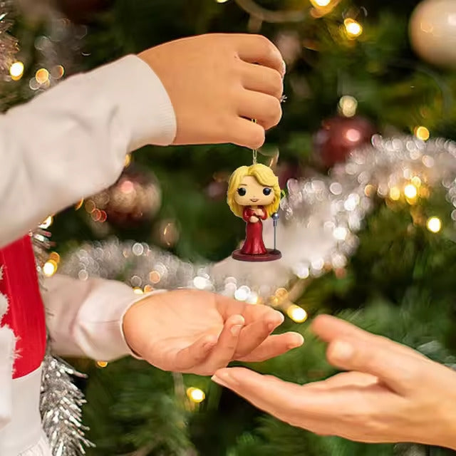 Child's hand holding a small figurine in front of a decorated Christmas tree.