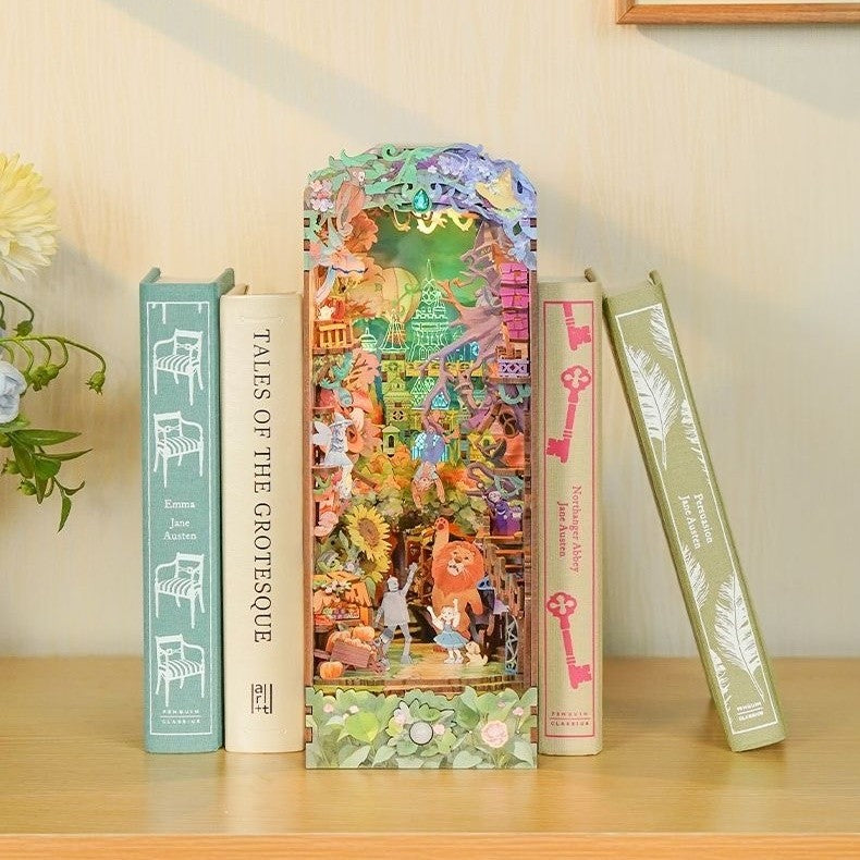 Decorative bookshelf with colorful Dorothy's Journey bookend shaped like a fairy tale scene inspired by Wizard of Oz on a wooden surface.