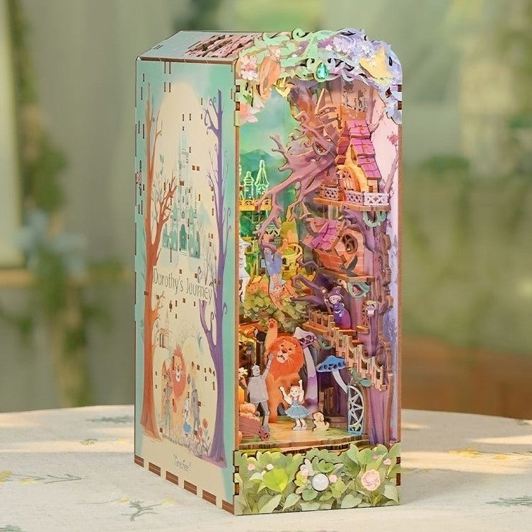 Decorative wooden book nook with colorful decoration of the fairy tale the Wizard of Oz scenes on a light surface.