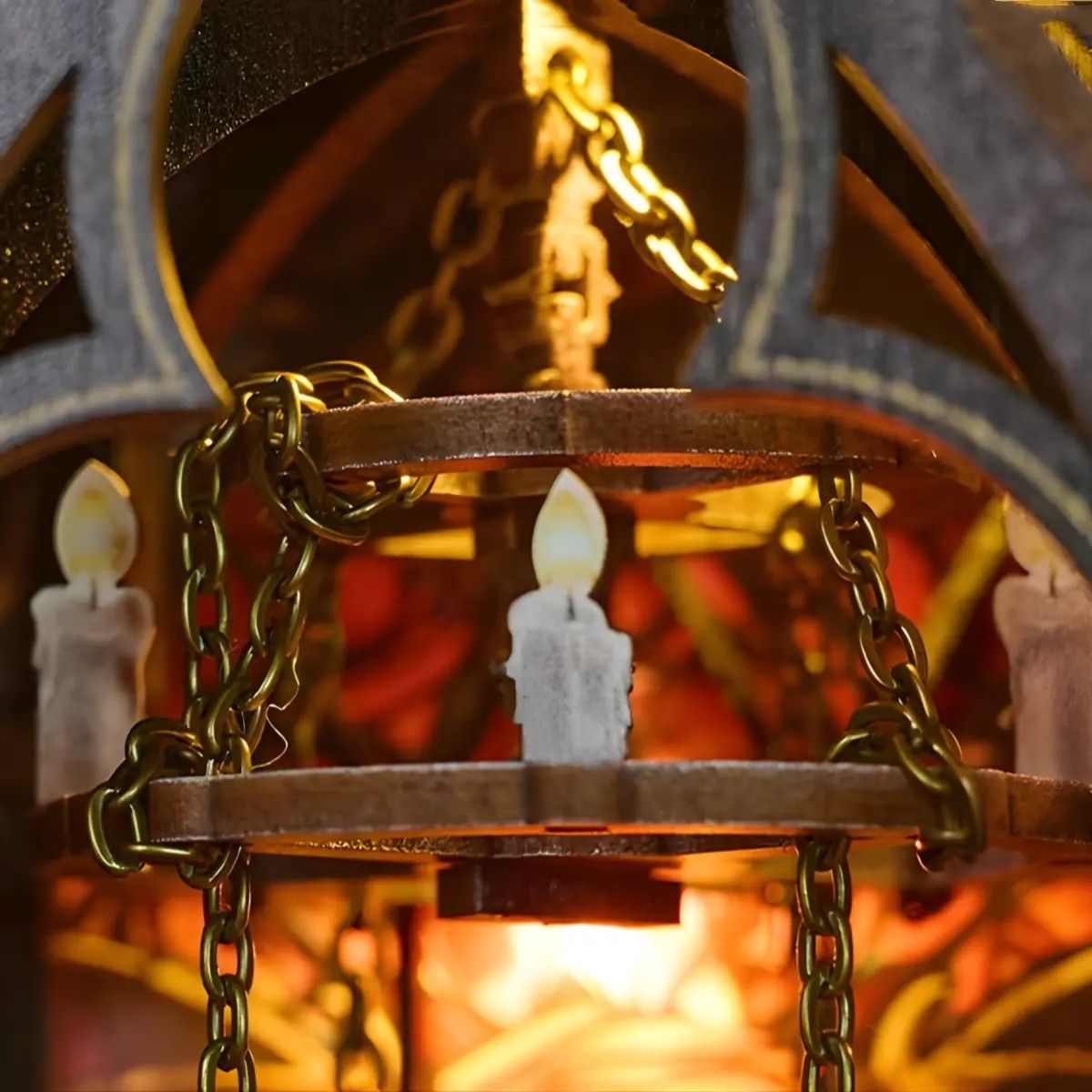 Close-up of a Gothic-style dragon tower miniature house with glowing candles inside , featuring gold chains and wooden gears.