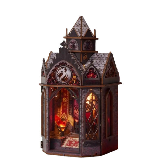 Gothic-style dragon tower miniature house with stained glass windows on a white background
