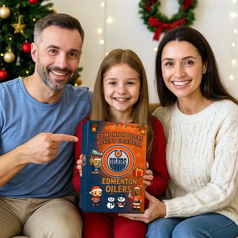 Family holding an Edmonton Oilers advent calendar in front of a Christmas tree.