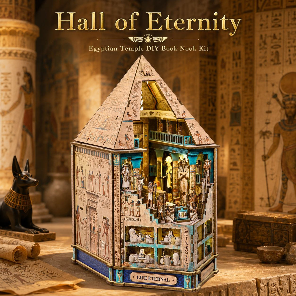 A 3D wooden book nook kit shaped like an Egyptian temple, labeled 'Hall of Eternity' at the top and 'Life Eternal' on the front. The kit is displayed in a beautifully styled ancient Egyptian-themed setting with hieroglyphics, scrolls, and a black Anubis statue.