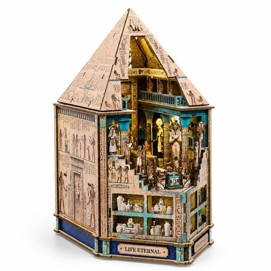 An intricate Egyptian-themed wooden miniature house labeled 'LIFE ETERNAL' on the front base, featuring detailed hieroglyphics, pharaoh figures, and multi-level interior scenes, set against a plain white background.