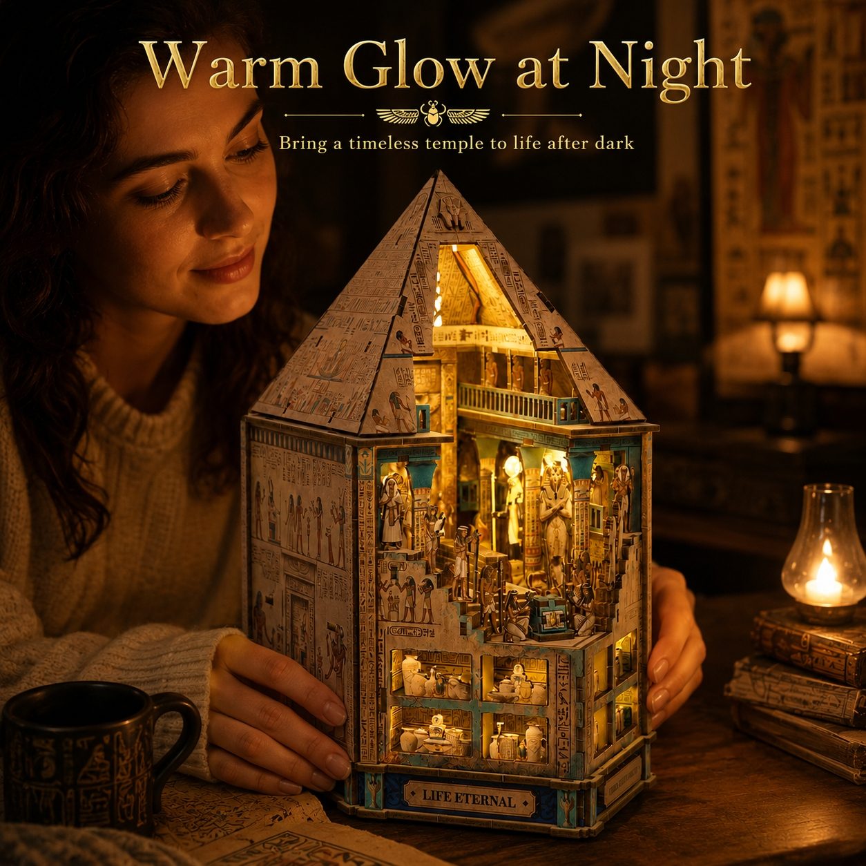 A woman holds a glowing, intricately detailed miniature house-shaped book nook on a wooden table, surrounded by warm lamps and books in a cozy room. Text at the top reads 'Warm Glow at Night'.