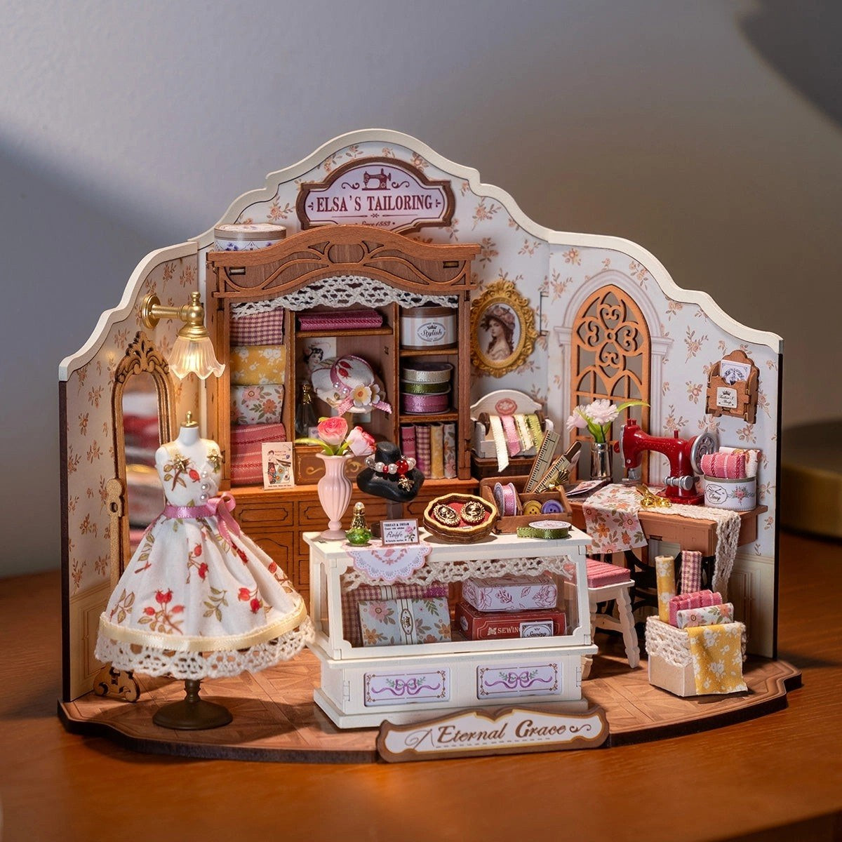 Miniature Sewing Room Diorama dollhouse with detailed interior and a dress on a stand.