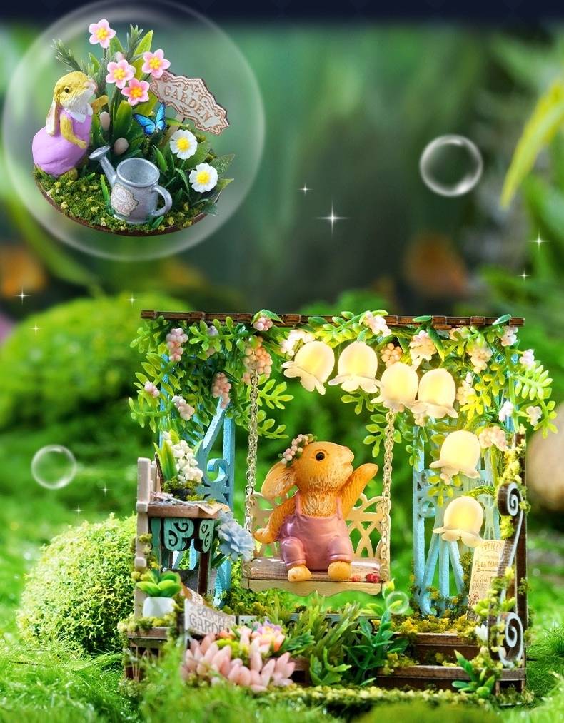 image displaying an assembled  Fairytale Garden DIY Miniature House Kit with lights on in a magic forest setting before nestling in the glass bottle 