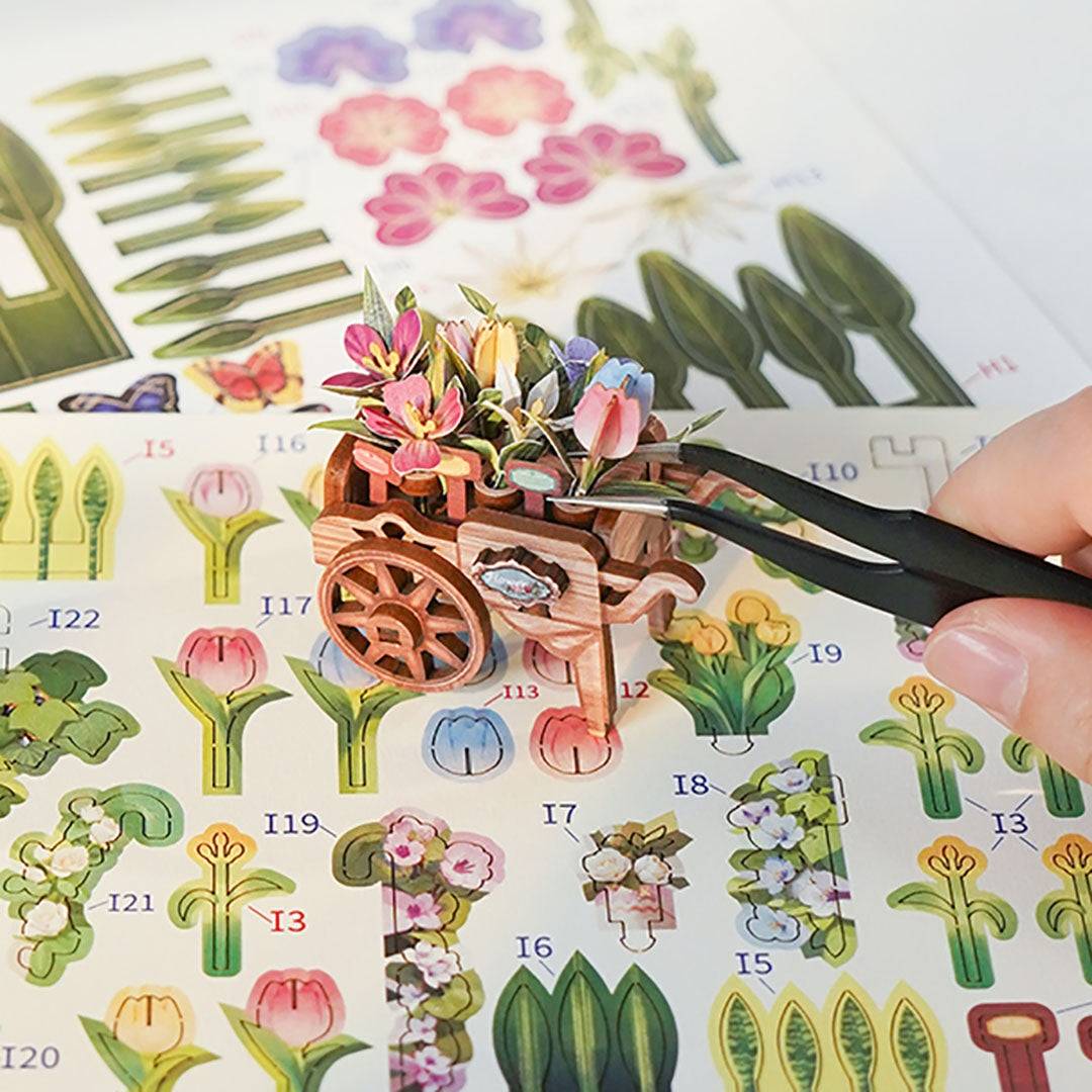 Small decorative garden scene with flowers and a flower trolley on a sheet of stickers.