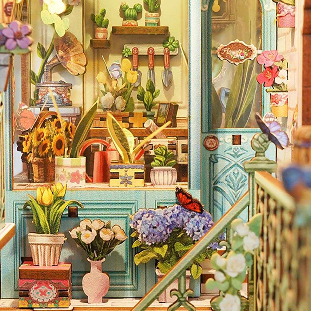 Colorful indoor garden scene with plants, flowers, and gardening tools.