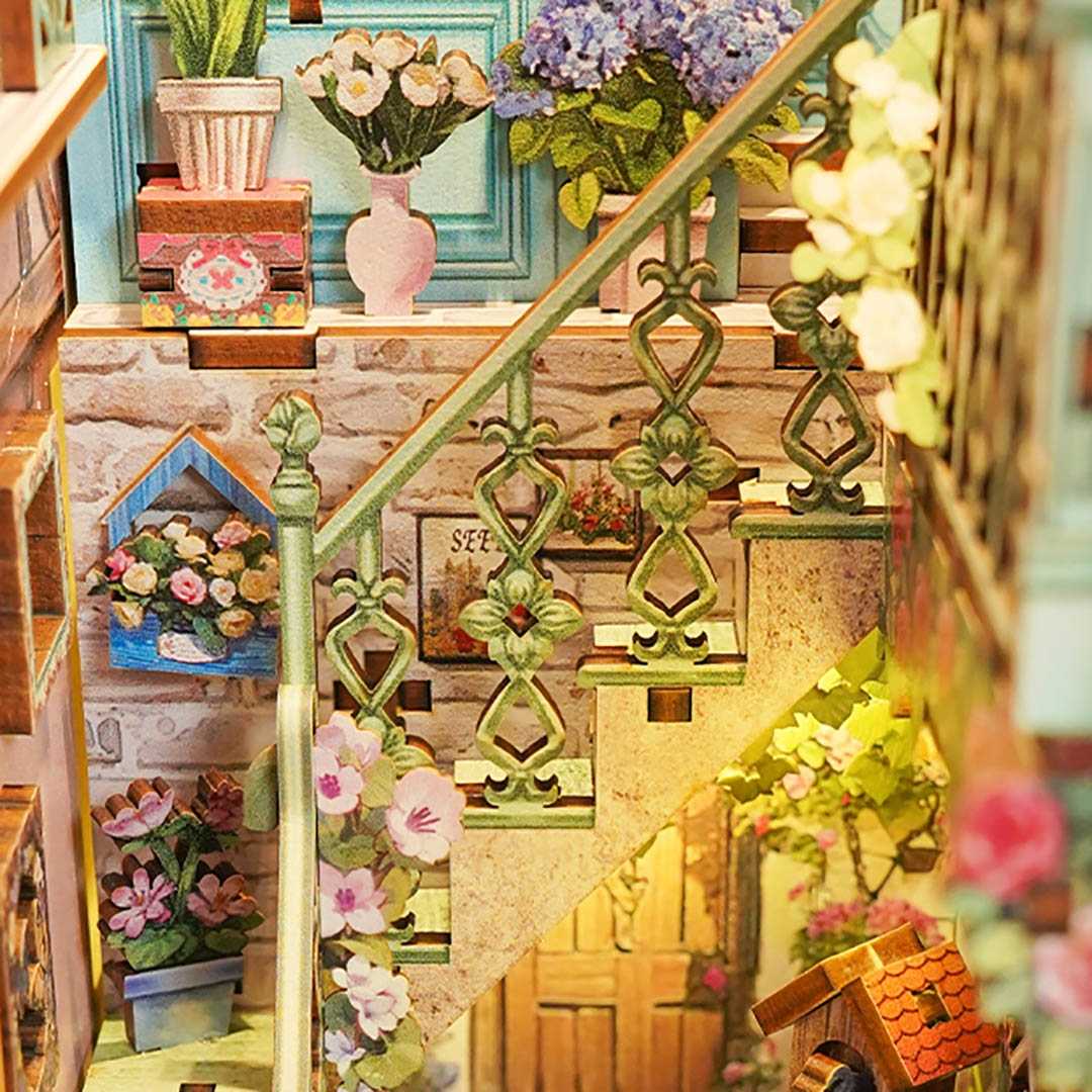 Decorative staircase with floral arrangements and a birdhouse.