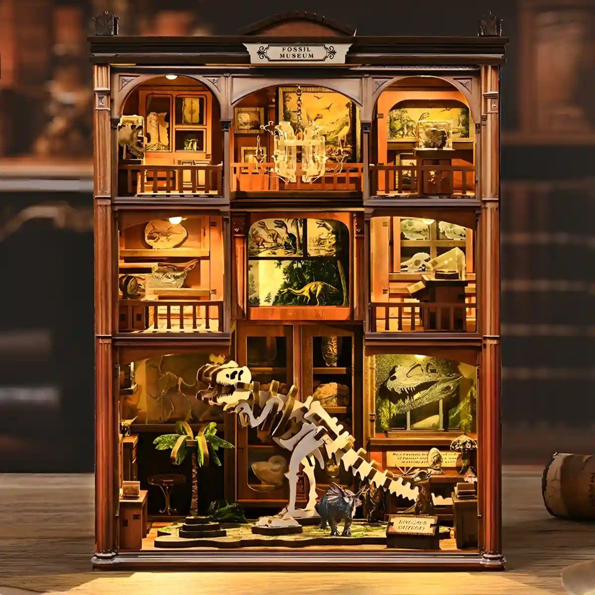 Wooden miniature museum with various exhibits including dinosaur skeletons and framed pictures.
