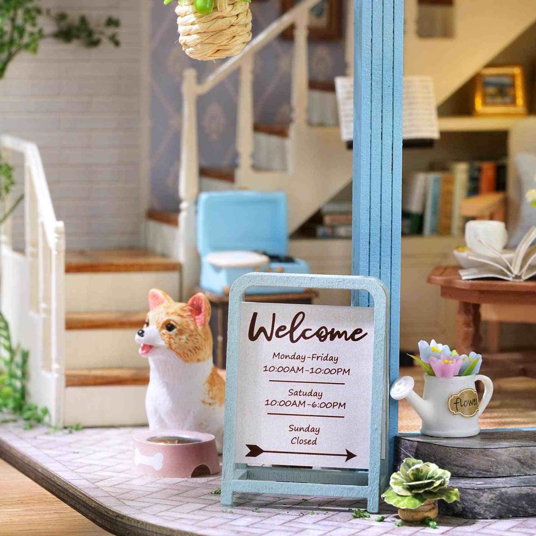 Miniature dog figurine with a 'Welcome' sign in a dollhouse setting